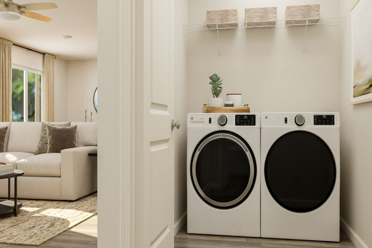A room with a washing machine and a couch.