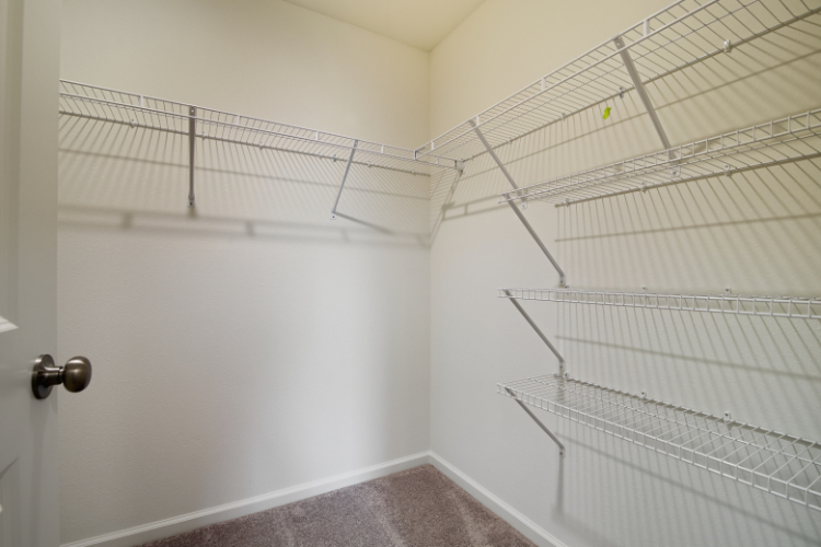 A white shower with a metal rack.