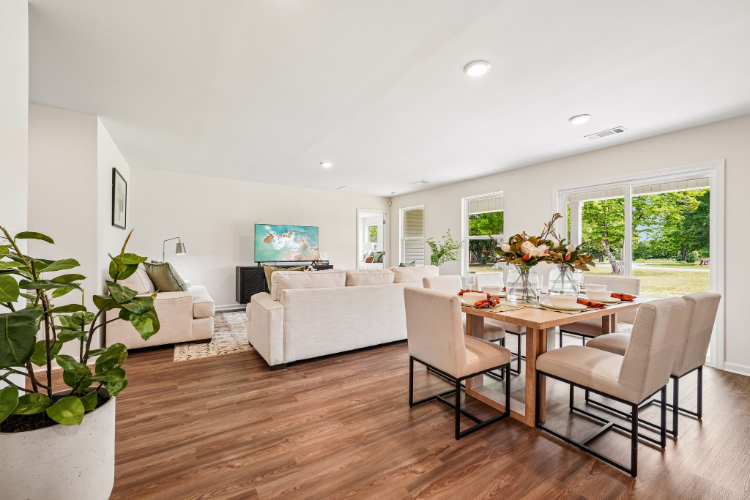 A living room with a table and chairs.