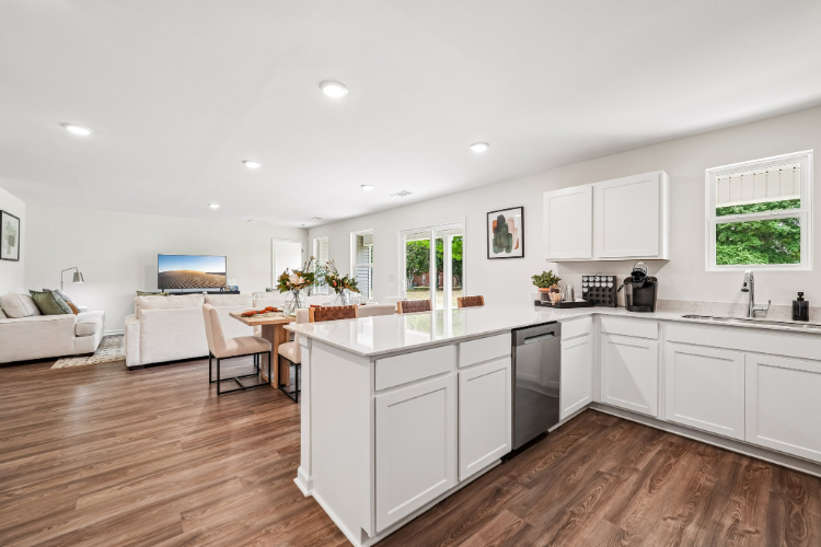 A kitchen with white cabinets.