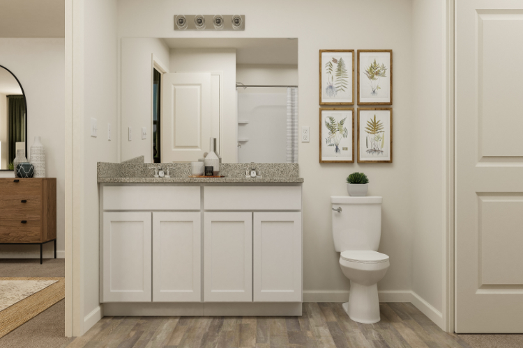A bathroom with white cabinets.