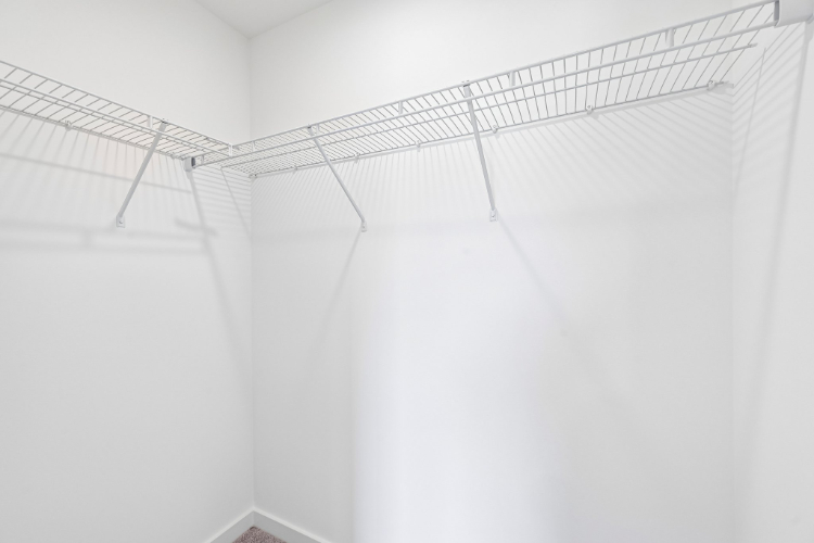 A white staircase with a metal railing.