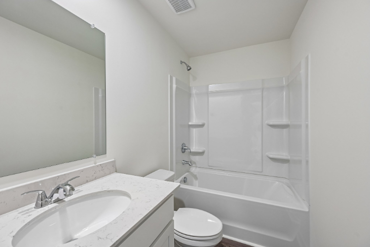 A bathroom with a sink toilet and shower.