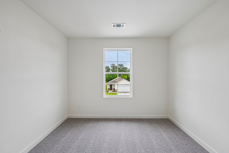 A room with a window and a carpet.