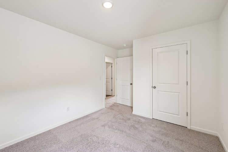 A hallway with white doors.