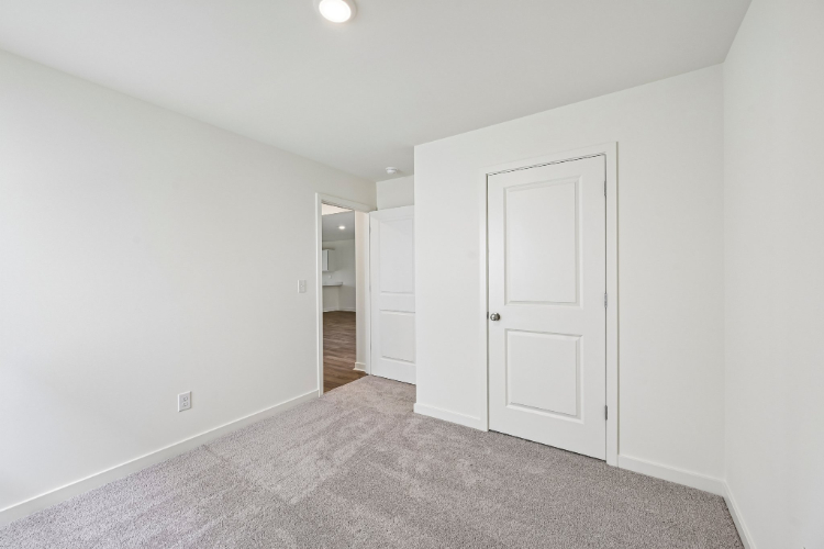 A hallway with white doors.