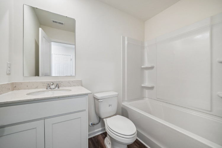 A bathroom with a toilet and sink.