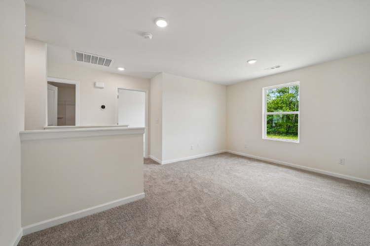 A room with white walls and a window.