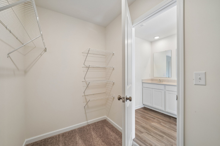 A white room with a white door and a white wall.