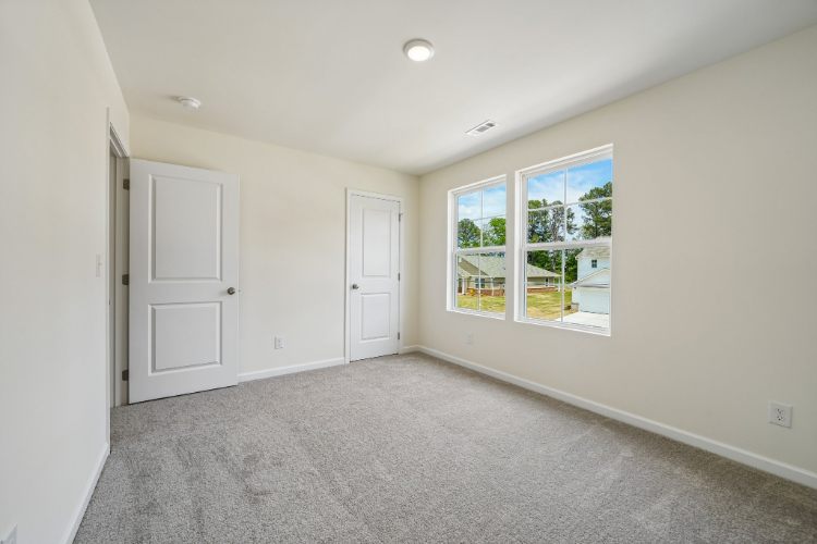 A room with white walls and a window.