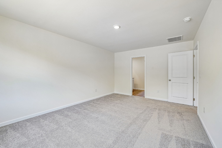 A hallway with white doors.