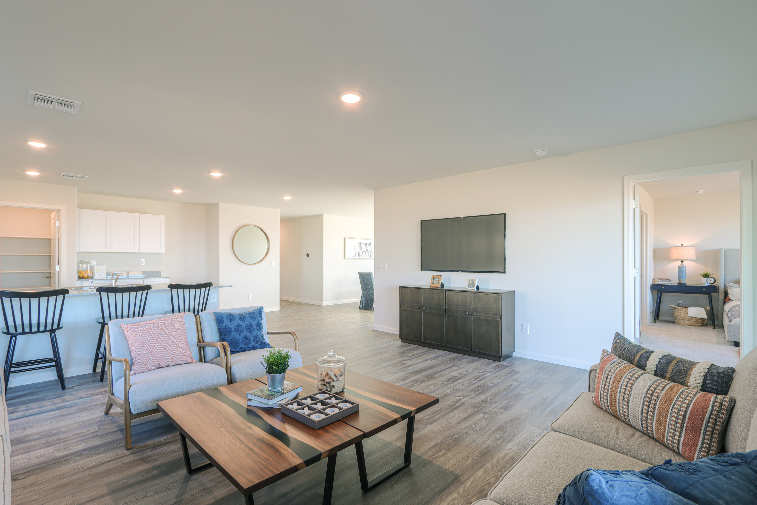 A living room with a tv and chairs.