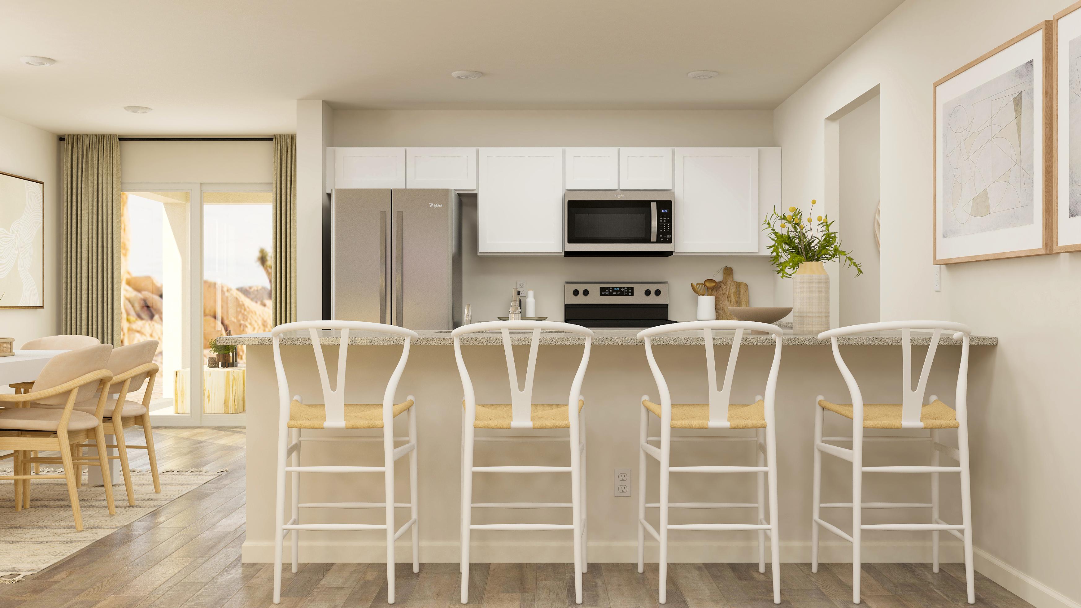 A kitchen with a table and chairs.