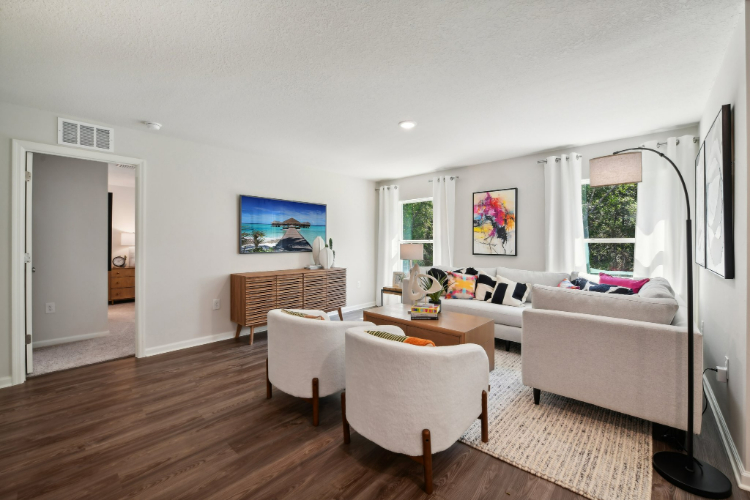 A living room with a couch and chairs.