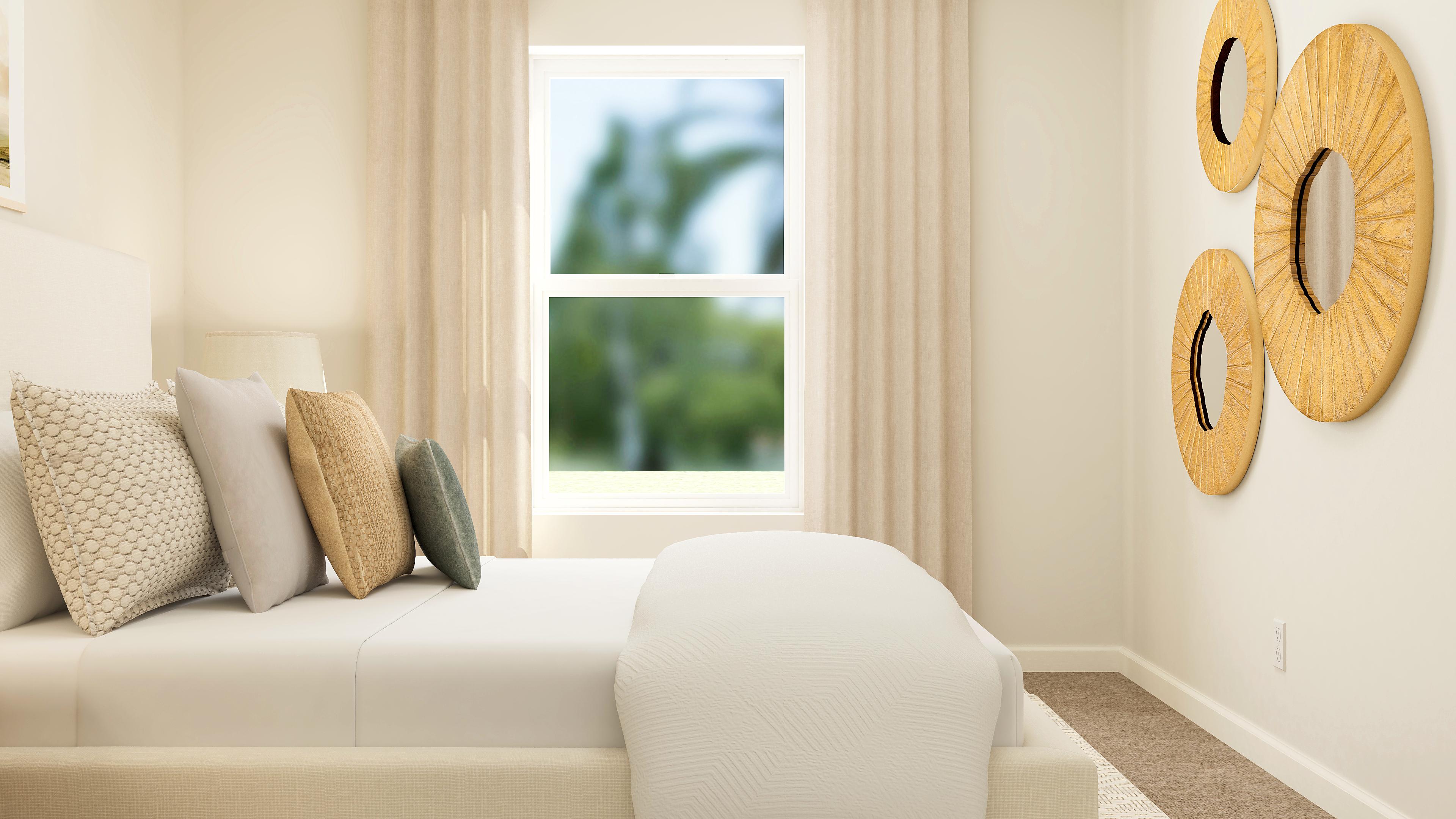 A white couch with pillows.