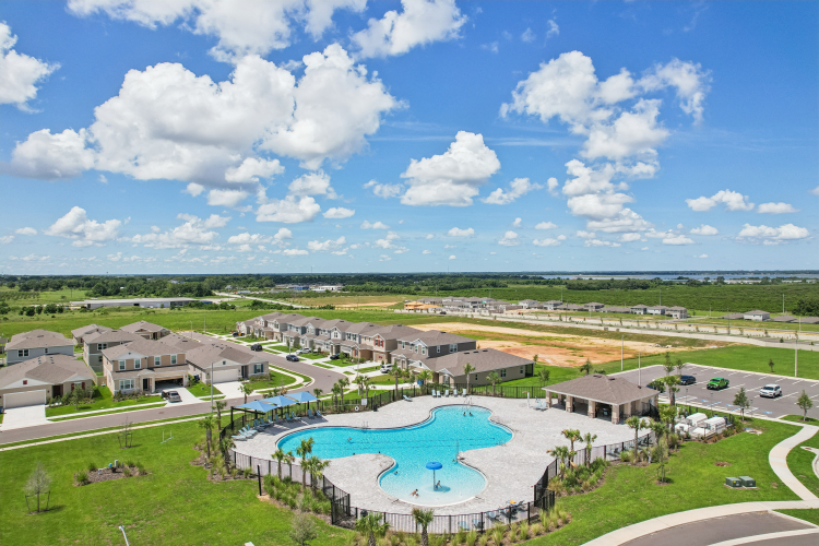 A large building with a pool in front of it.