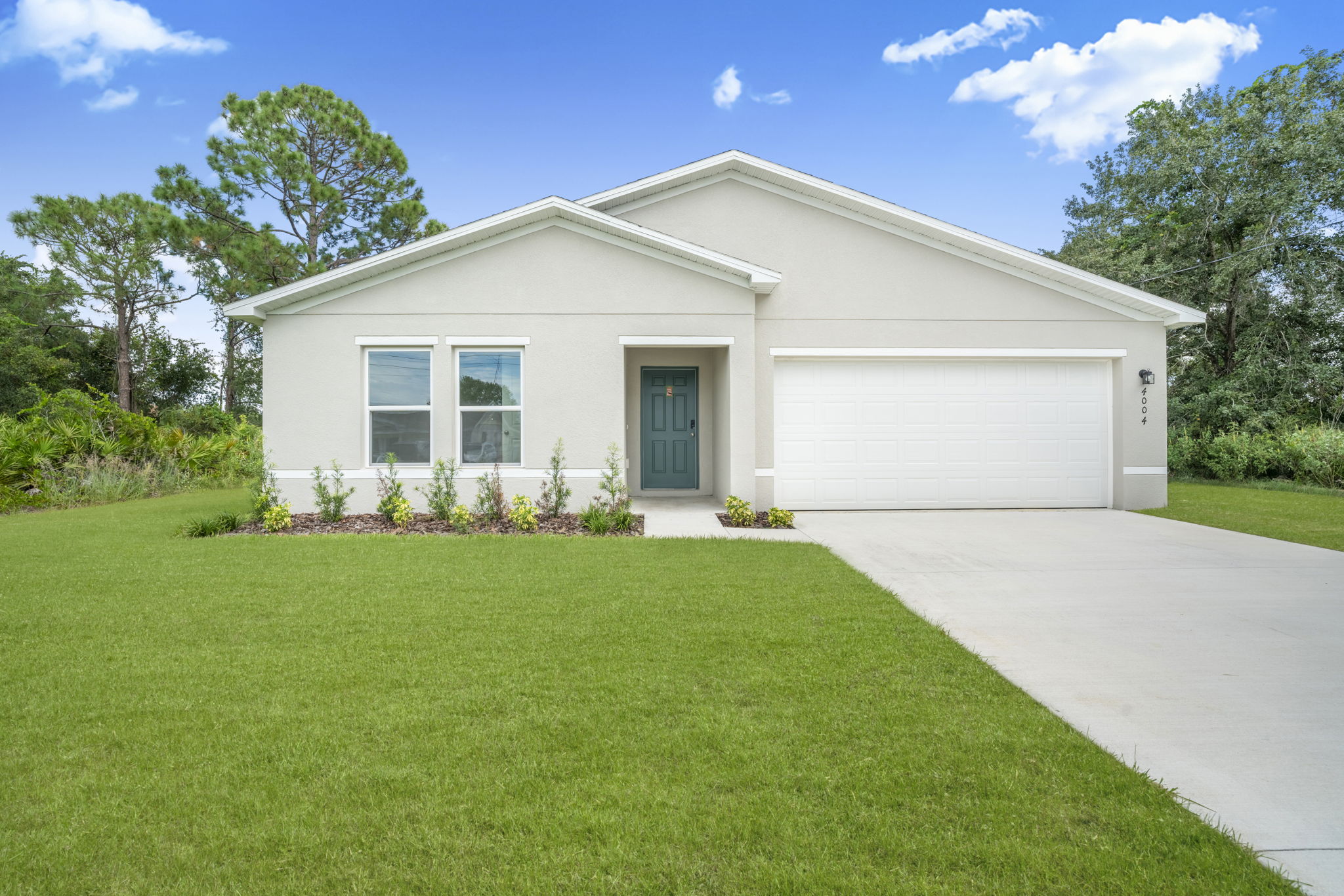 A white house with a driveway.