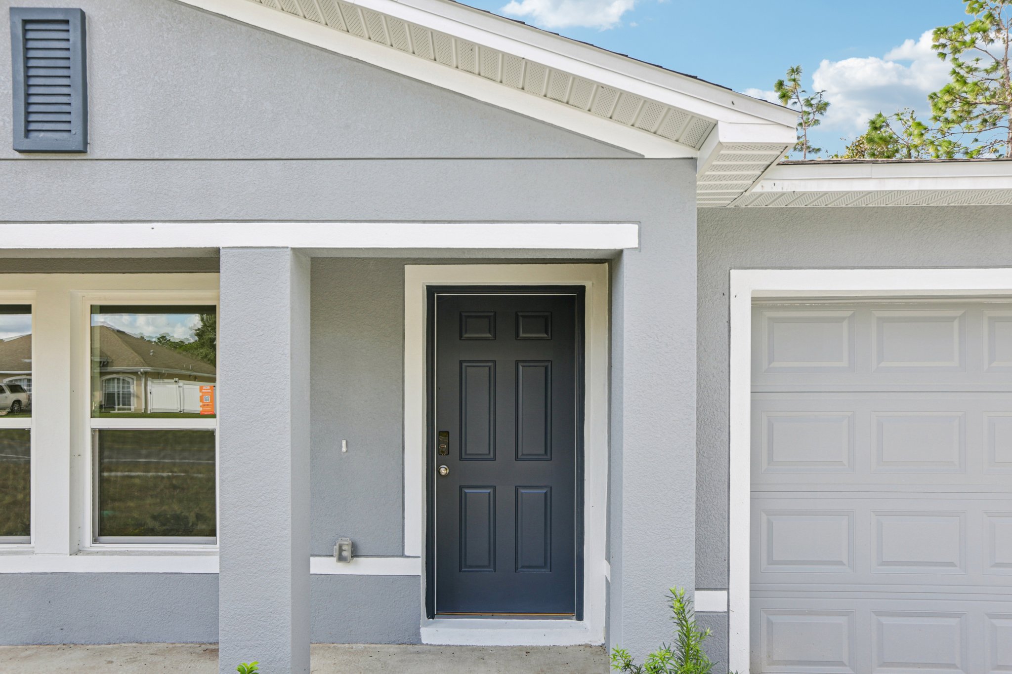 A white house with a black door.