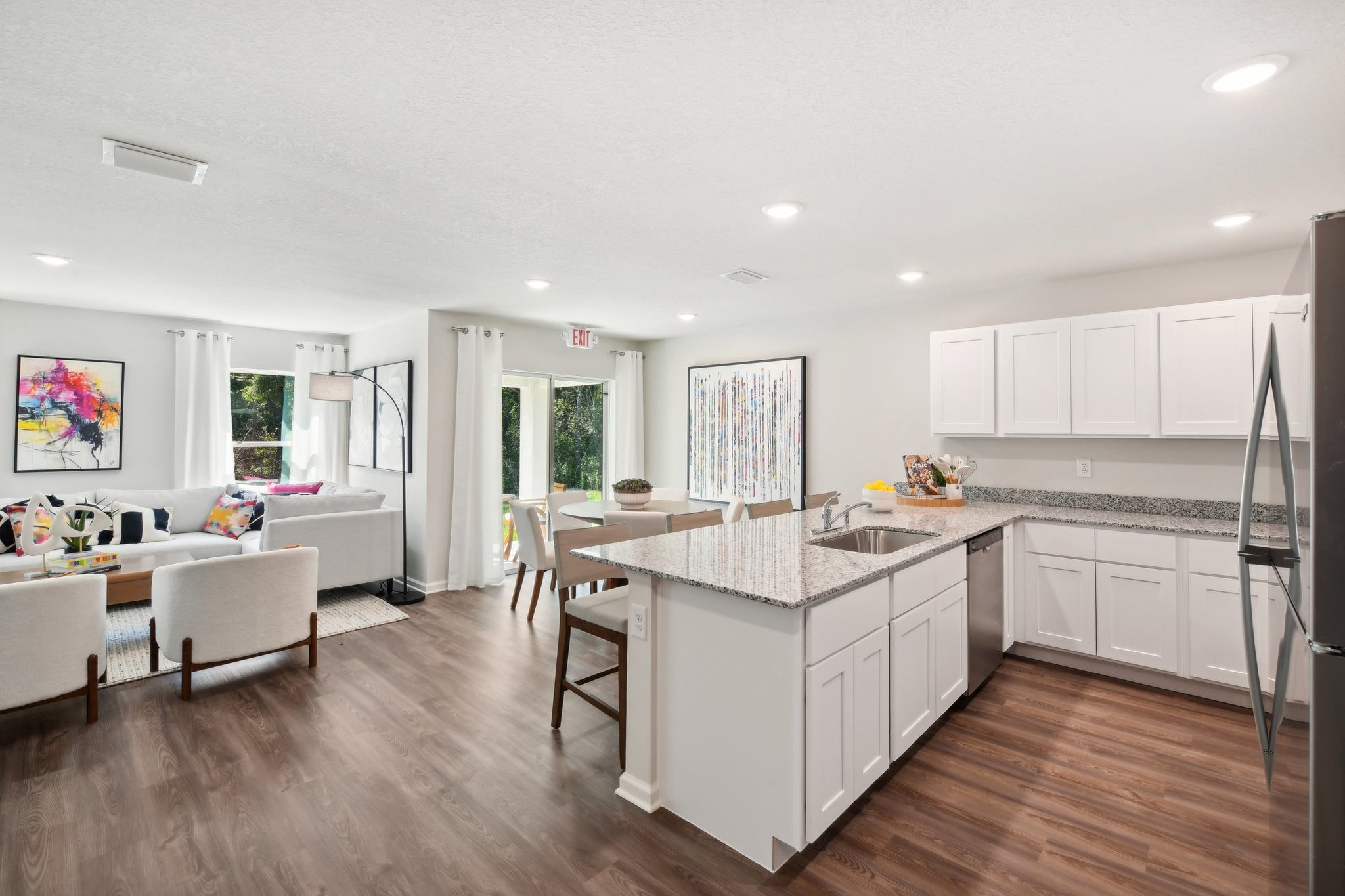 A kitchen with white cabinets.