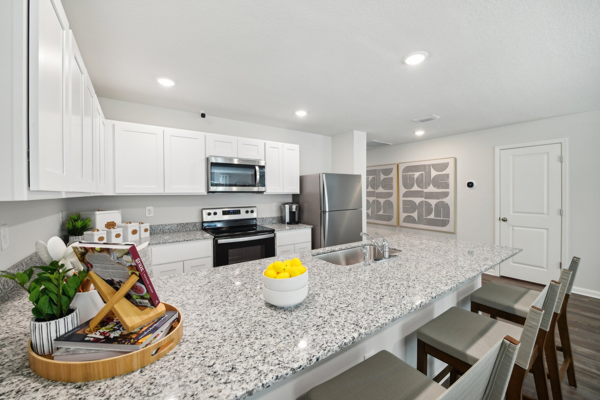 A kitchen with white cabinets.