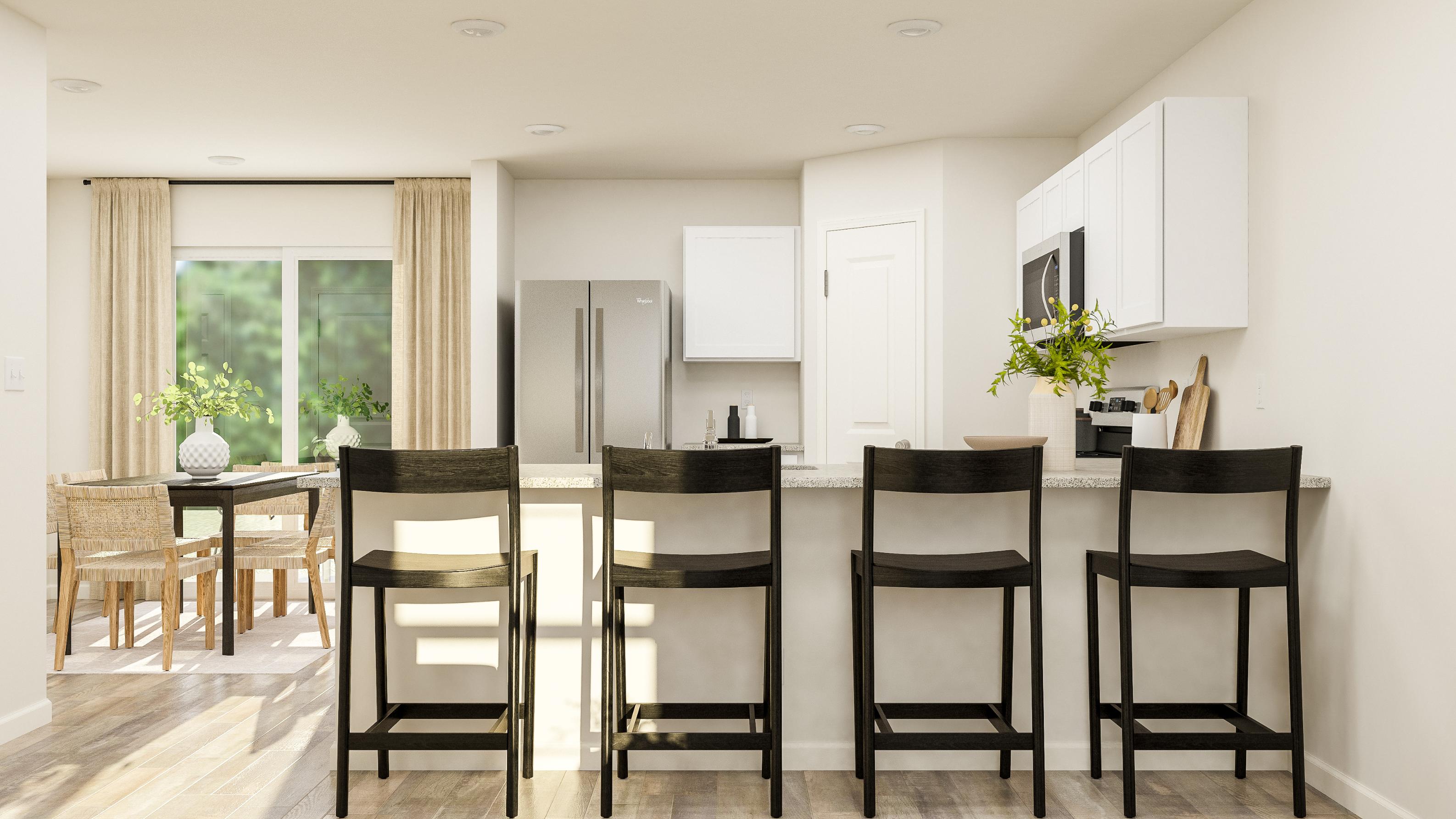 A kitchen with a dining table and chairs.