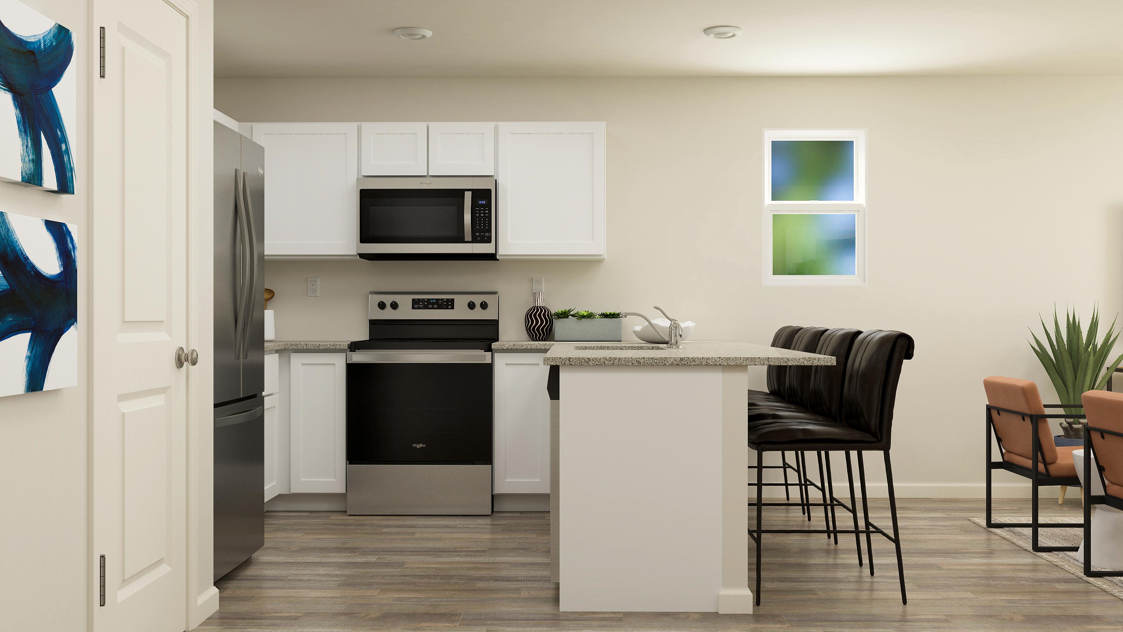 A kitchen with white cabinets.